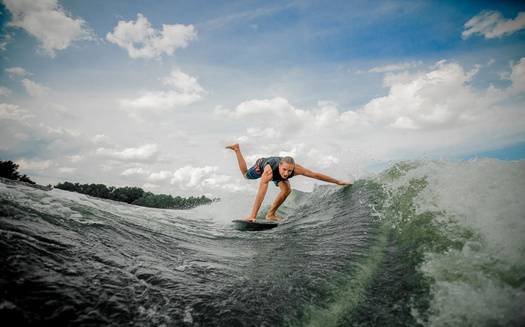 Wakesurfing requires a large wake behind a boat. A study is underway to determine the possible impact of those big waves, and other recreational boating, on lake and shoreline health in Minnesota.  (Adobe Stock)