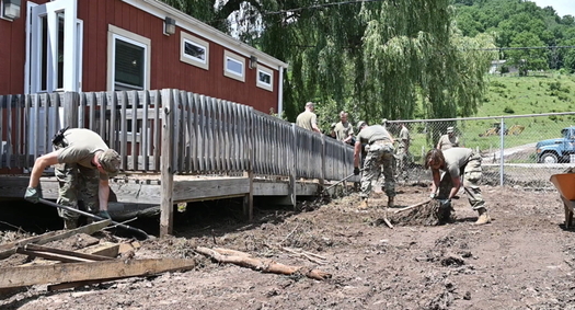 West Virginia National Guard members remove debris after a 2019 flood in Harman. Damaging floods have increased in the state along with the climate crisis. (U.S. National Guard)