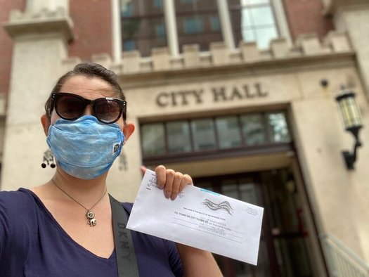 In New Hampshire, ballots returned by hand do not need a postage stamp, but those put in the mail require one first-class stamp. (Molly Biron)