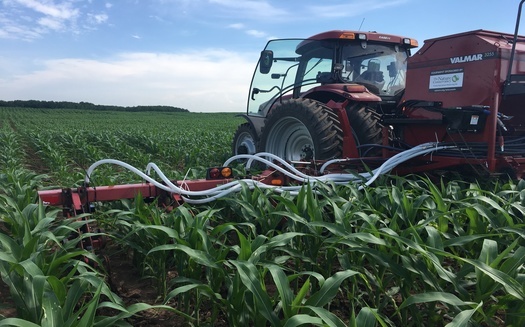 This Wisconsin farmer is using an air-seeder, which helps spread seeds for cover crops while work is being done on cash crops. The donated equipment is aimed at getting more farmers to adopt conservation practices. (Adobe Stock)