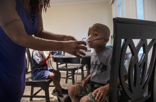 Four-year-old Jeremiah Galbreath receives a nebulizer treatment for asthma at his home in Bayboro.  (Travis Long)
