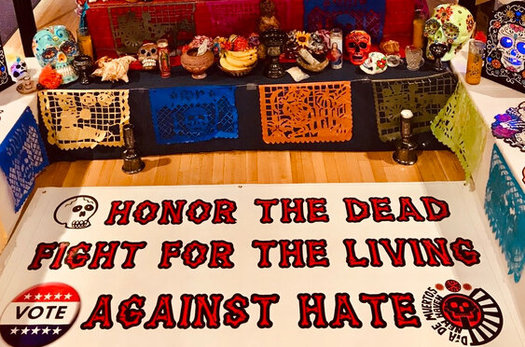 The public is invited to leave photos of their loved ones at a temporary altar built inside city hall in New Haven for Day of the Dead. (John Lugo)