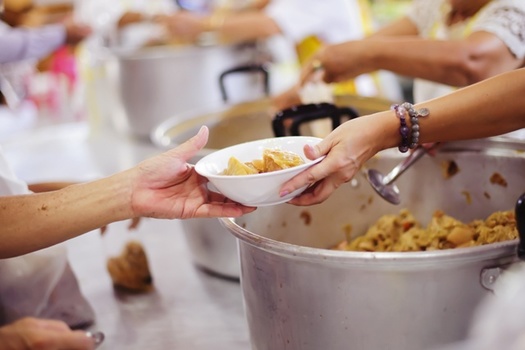 Volunteering at a soup kitchen or homeless shelter is one way to honor Dr. King's legacy of service. (Adobe Stock)