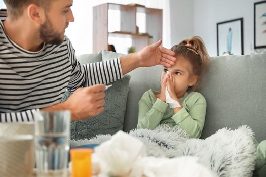 Parents without access to paid leave must often decide between staying home with a sick child or going to work and getting paid. (pixel-shot/Adobe Stock)
