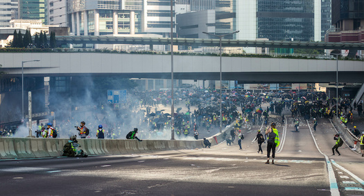 Protestors clash with police on a highway in Hong Kong. (Adobe Stock)