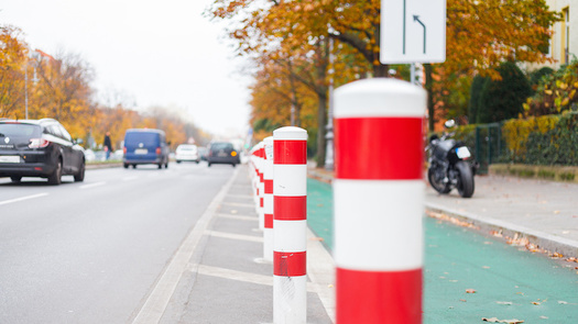 Research shows cities that plan and install protected lanes for cyclists have fewer bike and pedestrian fatalities than those that do not. (Adobe Stock)