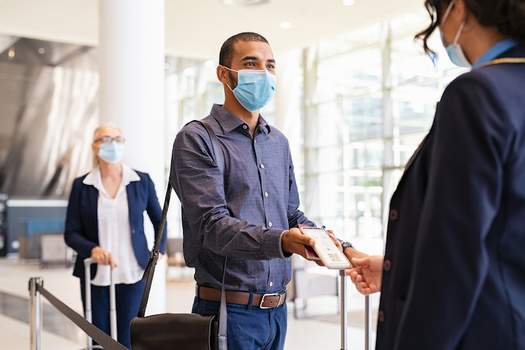 The CDC says fully vaccinated people can interact with others who are fully vaccinated without masks or distancing, but precautions are still necessary in certain instances, especially travel. (Rido/Adobe Stock)