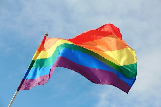 Advocates say a video which went viral of a boy cutting down a Pride flag in front of his school sends a negative message to Utah's transgender and LGBTQ students. (Adobe Stock)