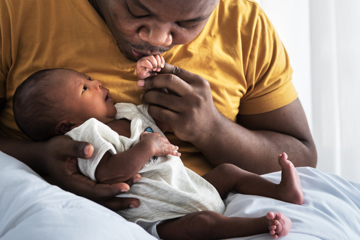 New dads - and moms - have a lot to consider when it comes to financial wellness for their families. (Anatta_Tan/Adobe Stock)