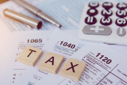 In a new poll, 22% of rural voters think raising taxes on those earning over $400,000 a year could hurt the economy, while 51% believe it would help it. (Adobe Stock)<br />