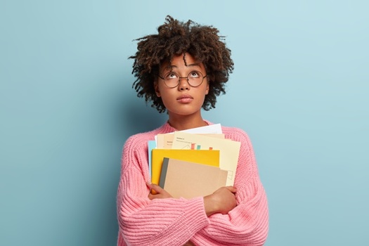 Black women carry roughly 20% more student debt than their white counterparts. (Adobe Stock)