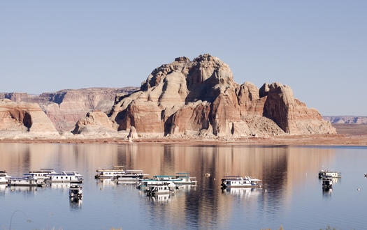 Lake Powell, a man-made reservoir situated on the Arizona-Utah border, draws upwards of 2 million visitors a year for boating and other forms of outdoor recreation. (forcdan/Adobe Stock)