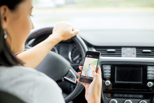 Uber and Lyft are among the app-based companies that successfully campaigned for a ballot initiative to allow them to classify their workers as independent contractors. (Kaspars Grinvalds/Adobe Stock)