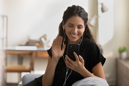 Some experts recommend using speakerphones and wired earbuds to help lower personal exposure to wireless radiation. (Fizkes/Adobe Stock)