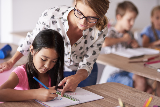 Advocates say South Dakota has made progress in compensating teachers, but still lags behind neighboring states, including trailing North Dakota educators by $4,000 in annual salary. (Adobe Stock)