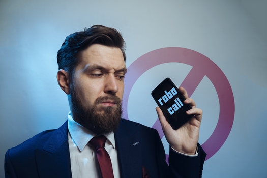 A new report finds more than 80% of U.S. telecom carriers, both big and small companies, are not doing all they can to stop illegal robocalls. (Phoenix021/Adobe Stock)