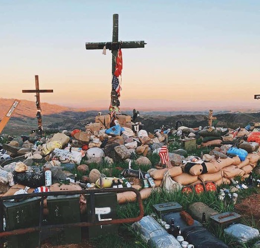 Marines carry personal items to the top of a hillside near Camp Pendleton in California, contributing to the living memorial. (Katrina Finkelstein)