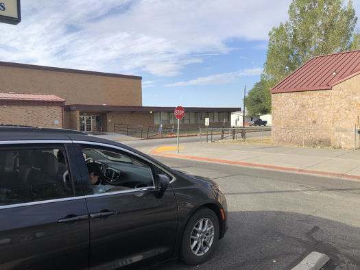 A student at Owyhee Consolidated School studies in the parking lot in order to use the building's Wi-Fi signal. (Lynn Manning John)