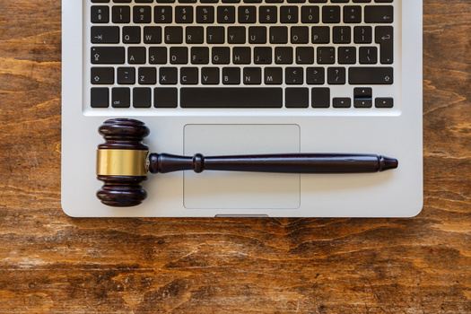 Studies have shown defendants are more likely to have judges set higher bail amounts when their hearings are conducted by video. (Rawf8/Adobe Stock)