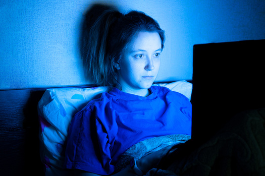 The harms from the blue light of screens is a particular concern for children and teens. (Yekatseryna/Adobe Stock)