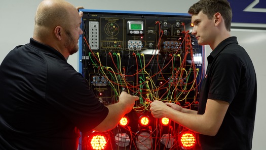 An instructor uses an advanced electrical trainer to educate a student at NVI Blairsville, which opened this month. (NVI Blairsville)