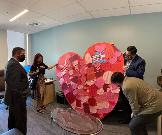 Assemblyman Joaquin Arambula, D-Fresno, inspects the giant Valentine sent by advocacy groups to thank Gov. Gavin Newsom for supporting an expansion of Medi-Cal to more undocumented adults. (Health4All Coalition)