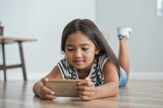 According to the Pew Research Center, 60% of parents report their children begin engaging with smart devices before age five. (Adobe Stock)