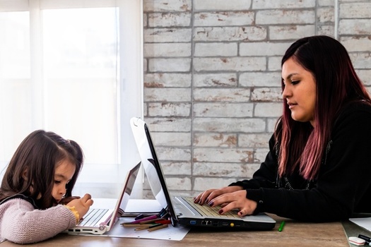 Experts contend that policies that support affordable child care and improve paid leave would help further narrow the gender wage gap. (Adobe Stock)