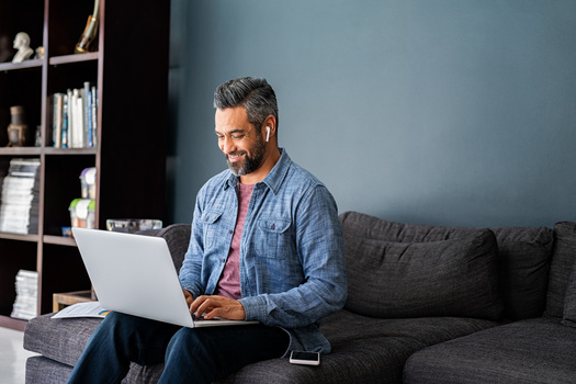 In a January Pew Research Center poll, 64% of respondents said they work from home because their office was closed, while 36% choose to work from home despite their offices being open. (Adobe Stock)