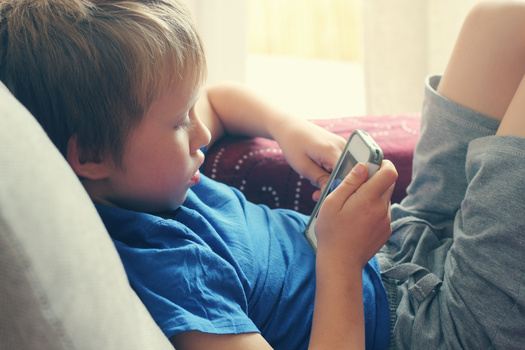 Seven in 10 parents say their kids have interacted with a smartphone before age 11. (dubova/Adobe Stock)