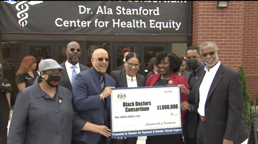 Philadelphia lawmakers present a check for $1 million to Tracy Wood, executive director of Black Doctors Consortium. (Screenshot via Facebook Live)