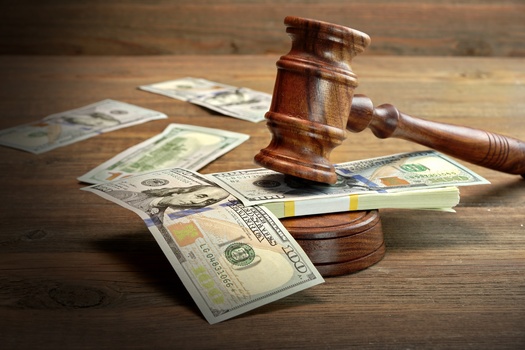 Juvenile-justice advocates in Michigan urge policy action on the issue of youth and families having too many court fines and fees to pay off. (Alex/Adobe Stock)