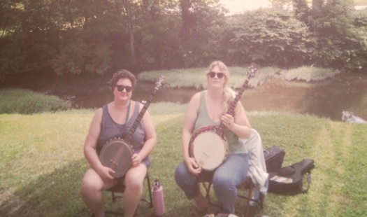Larah Helayne, left, and Montana Hobbs, right. Helayne uses a rainbow strap for their banjo to highlight their LGBTQ+ identity. Others at Cowan did the same. (Rebecca Stern)