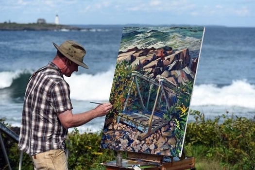 Maine artist Russel Whitten creates an ocean scene at East Point Audubon Sanctuary at Biddeford Pool. (Elizabeth Creamer/Maine Audubon)