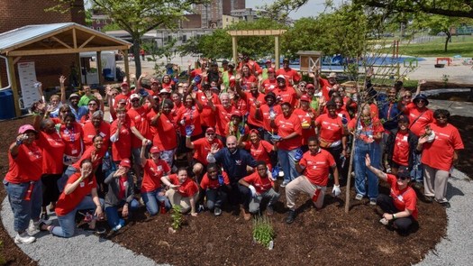 AARP Maryland volunteers celebrated after the initial construction of a park and garden space at Baltimore's James McHenry Elementary School was completed in 2018. (Todd Nash)