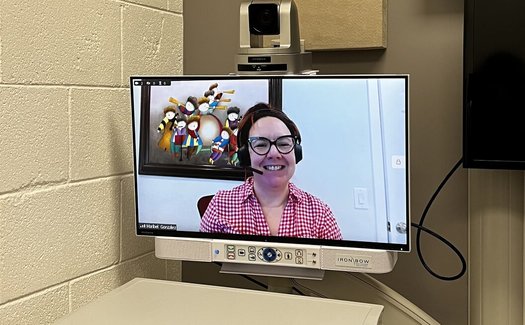 Dr. Maribel Gonzalez, a child psychiatrist, waits on-screen for her next patient in one of Shasta Community Health Center's telemedicine exam rooms in California. (Annelise Pierce)