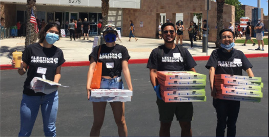 Volunteers from the group Election Protection coalition recently handed out food to voters in line at the Desert Breeze Community Center in Las Vegas; the group will be on hand today to answer questions at polling sites around the state. (Silver State Voices)