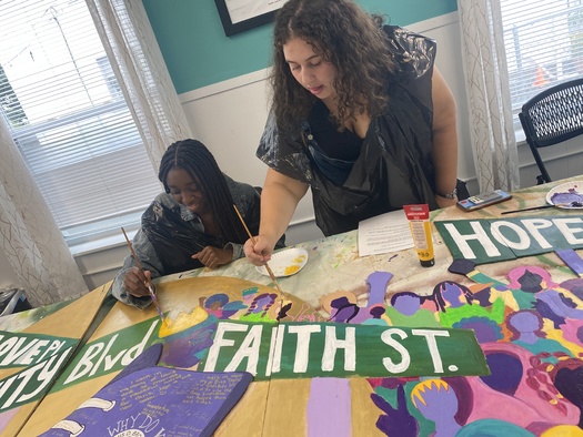 Community members work on a peace mural for the Louis D. Brown Peace Institute. Along with the Boston Public Health Commission, the group offers a Survivors Outreach Services program to deliver coordinated services to families affected by homicide. (Louis D. Brown Peace Institute)