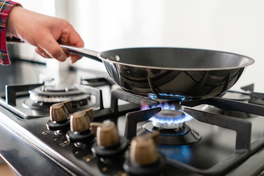 Research shows that cooking with natural gas can emit toxic fumes such as methane and nitrogen dioxide into the home and the atmosphere. (malkovkosta/Adobe Stock)