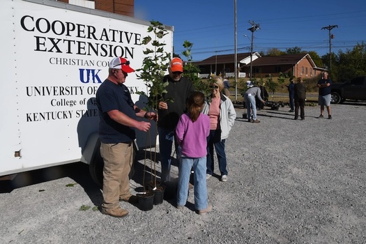 Master Gardeners Nate Picken and Frank Amaro along with Pembroke Mayor Judy Peterson help Avery Grace select trees to be planted at Pembroke School. (Photo courtesy Toni Riley)