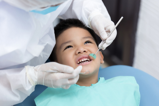 According to McGinley, common problems during the age of six to 12 include malocclusion, like cross-bites or overbites and the development of crooked or crowded teeth. (Adobe Stock) 
