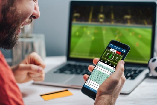 Problem gambling experts say commercials for sports-betting apps often portray the activity as a fun, social event, with not enough information about the potential risks. (wpadington/Adobe Stock)