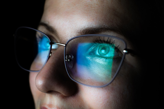 People who experience fatigue from long duration screen use can consider blue light reading glasses that filter blue light and reduce glare. (Adobe Stock)