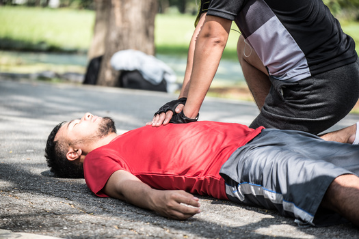According to the American Heart Association, in the case of cardiac arrest, calling 911 immediately and performing chest compressions until paramedics arrive and can use a defibrillator to shock the heart back into a normal rhythm can reverse cardiac arrest if done within a few minutes. (Adobe Stock)