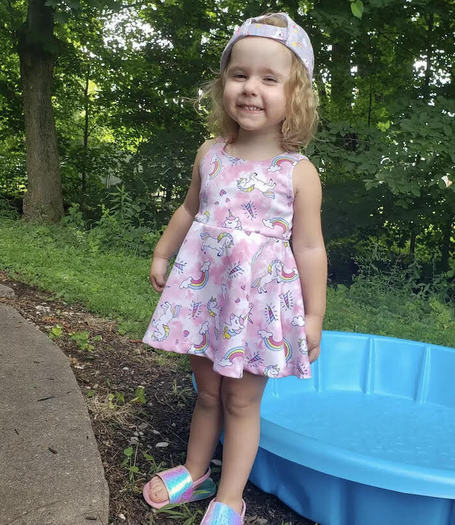 East Palestine, Ohio, resident Kyla Rose Cozza, 3, plays in her backyard just a few steps away from one of the creeks now contaminated with toxic chemicals after a massive train derailment Feb. 3. (Jamie Cozza)