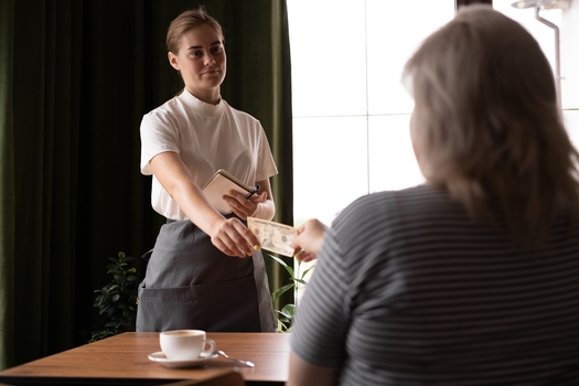 Tipped workers, such as waiters, must depend on the generosity of their customers to make a living wage. (Adobe Stock)