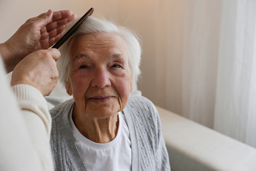 In a new AARP report, the work of unpaid family caregivers in Wisconsin is valued at $16.97 per hour. (Adobe Stock)