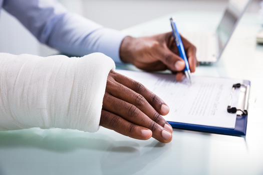 Injury compensation cases can often be uphill battles for workers. (Andrey Popov/Adobe Stock)
