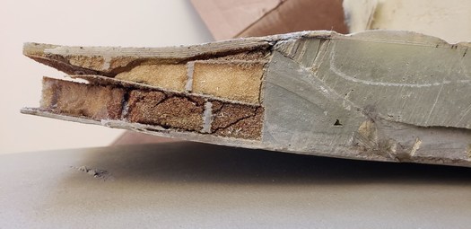 Researchers in North Dakota say they've been able to examine the structures of two decommissioned wind blades in different conditions. Inside, they found materials such as thick layers of Fiberglas and balsa wood or foam, sandwiched between thin layers of Fiberglas. (Photo courtesy of EERC)