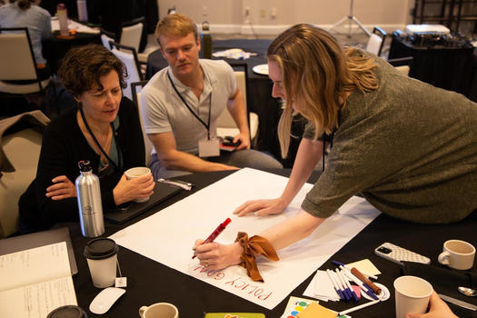 Siena Chrisman of State Innovation Exchange, Kellon Patey of People's Action and Caitlin Cromwell of Northern Plains Resource Council discuss policy goals at the 2023 Rural Policy Action Summit. (Photo courtesy of Rural Democracy Initiative)